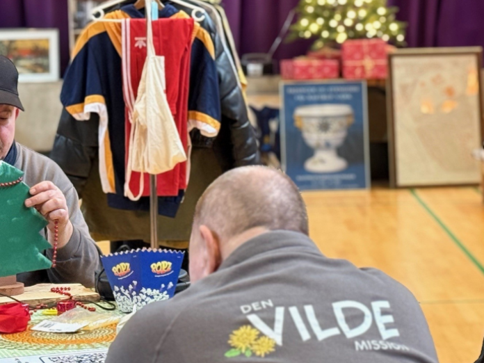 Billede fra julemarked i den vilde mission. Man ser en mand med ryggen til, der har logo på sin jakke fra Den Vilde Mission.